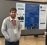 Me standing beside my poster on brain tumor classification with fuzzy clustering and a convolutional neural network.