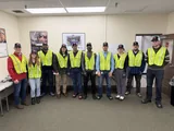 The group in safety vests and caps, ready for the production tour.