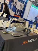 A table of fracture-fixation implants and instruments I passed in the exhibit hall, with a femur nail system on display.