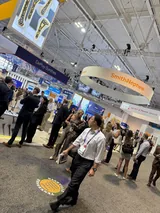 The busy main aisle of the exhibit hall, with large manufacturer stands on either side.